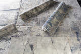 Close-up of Sapcote Textured Luxe Area Rug, showing charcoal, beige, and blue abstract pattern and machine-woven texture. Styleshot