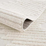 Close-up of the Palimbang Cream 3D Rug showing its geometric pattern, plush texture, and durable machine-woven construction. Fold
