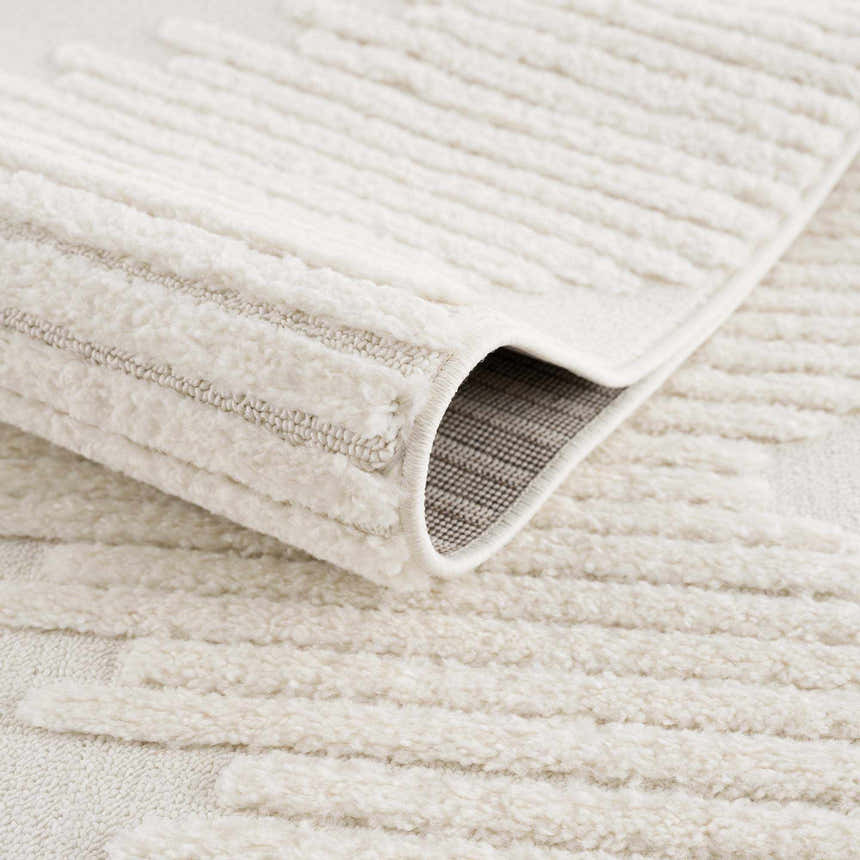 Close-up of the Palimbang Cream 3D Rug showing its geometric pattern, plush texture, and durable machine-woven construction. Fold