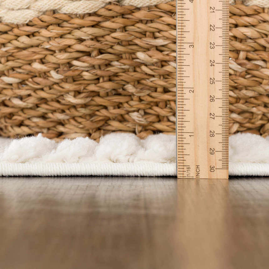 Close-up of the cream Palimbang 3D Rug showing the texture and pile height with a ruler for scale. Woven rug detail. Pile