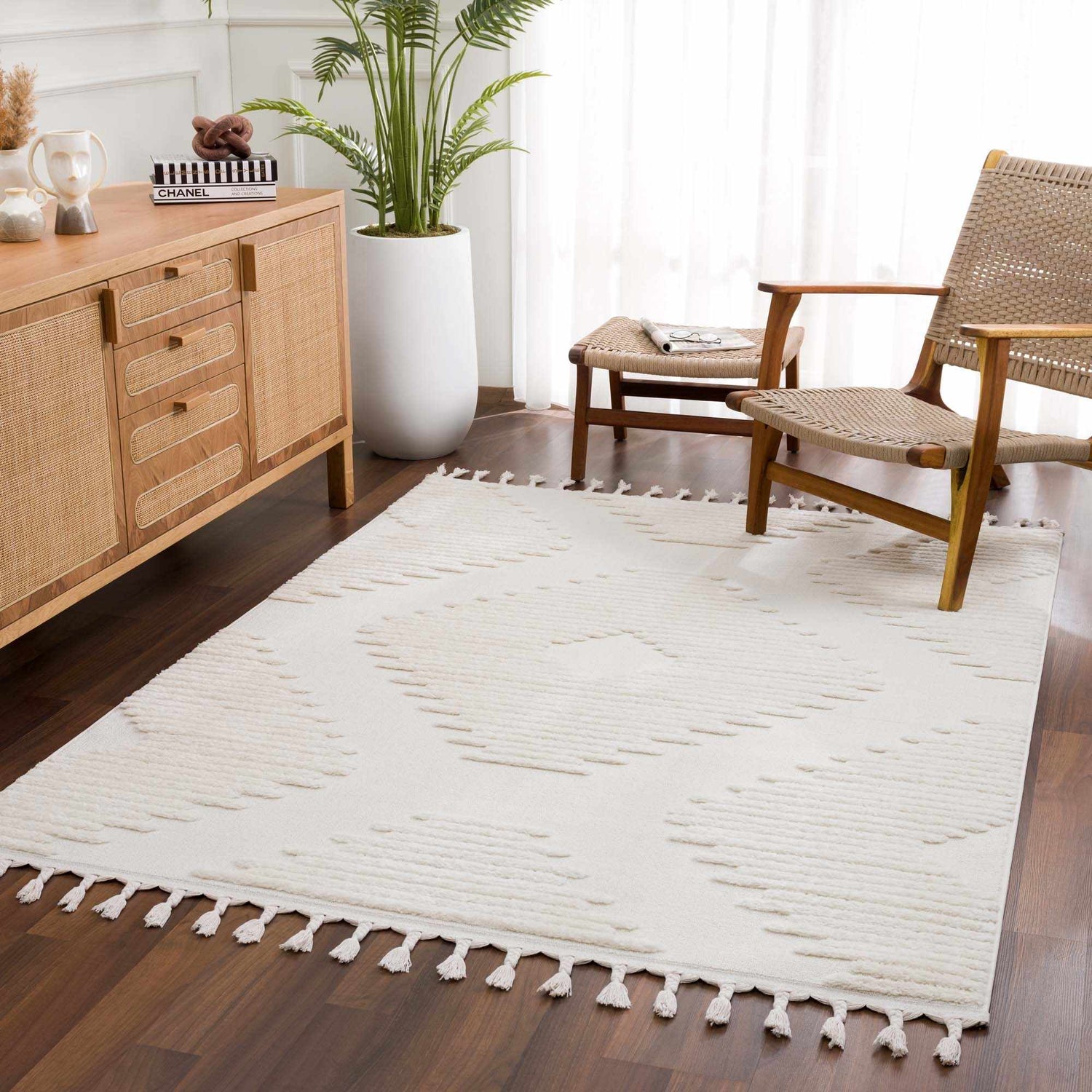Living room scene with a Palimbang Cream 3D Rug, wood furniture, and a potted plant creating a modern, neutral, and inviting space. Roomscene-Rectangle
