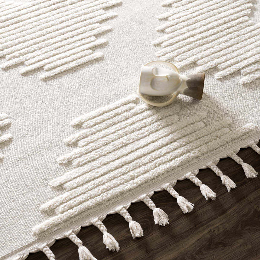 Close-up of the Palimbang Cream 3D Rug showing its geometric design, tassels, and textured, high-pile construction. Styleshot
