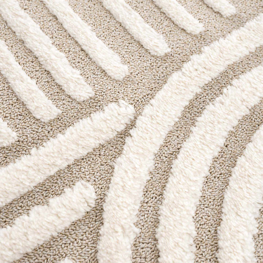 Close-up of the Moise Area Rug showing beige and cream colors with a textured, contemporary striped design. Texture