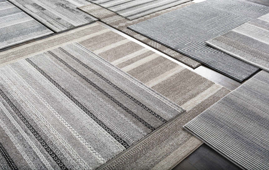 Close-up of Artois area rugs in black, cream, gray, and slate blue. Jute and polypropylene rugs with bohemian and modern designs. Styleshot