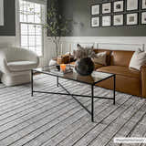 Living room scene with a Naivasha Elegant High/Low Area Rug in charcoal and cream, leather sofa, and glass coffee table. Roomscene-Rectangle