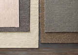 Close-up of hand woven Cirencester Area Rug in ivory, medium gray, and brown; natural fibers texture detail. Styleshot