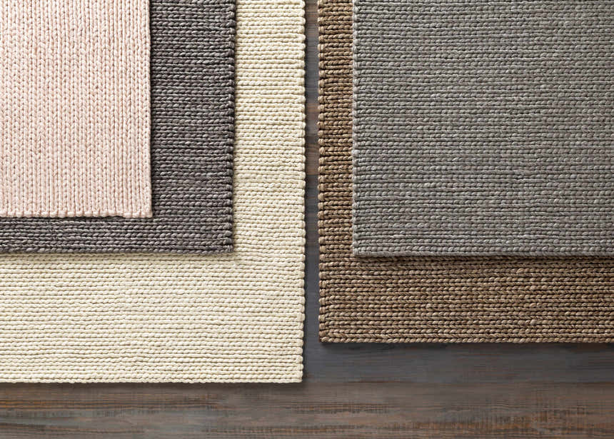 Close-up of hand woven Cirencester Area Rug in ivory, medium gray, and brown; natural fibers texture detail. Styleshot