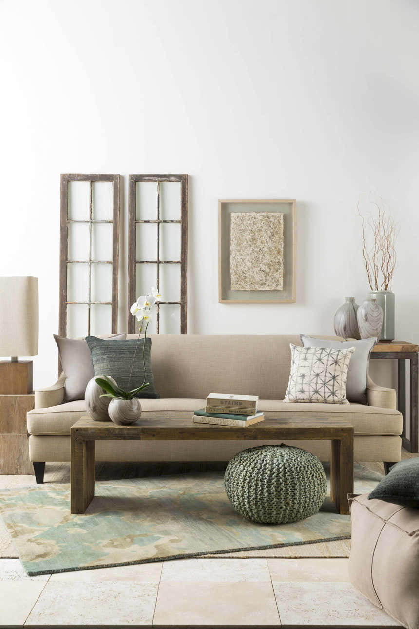 Living room scene with Briceville Premium Area Rug in ivory, green, blue, peach, and wheat colors. Contemporary, mid-century modern style. Styleshot