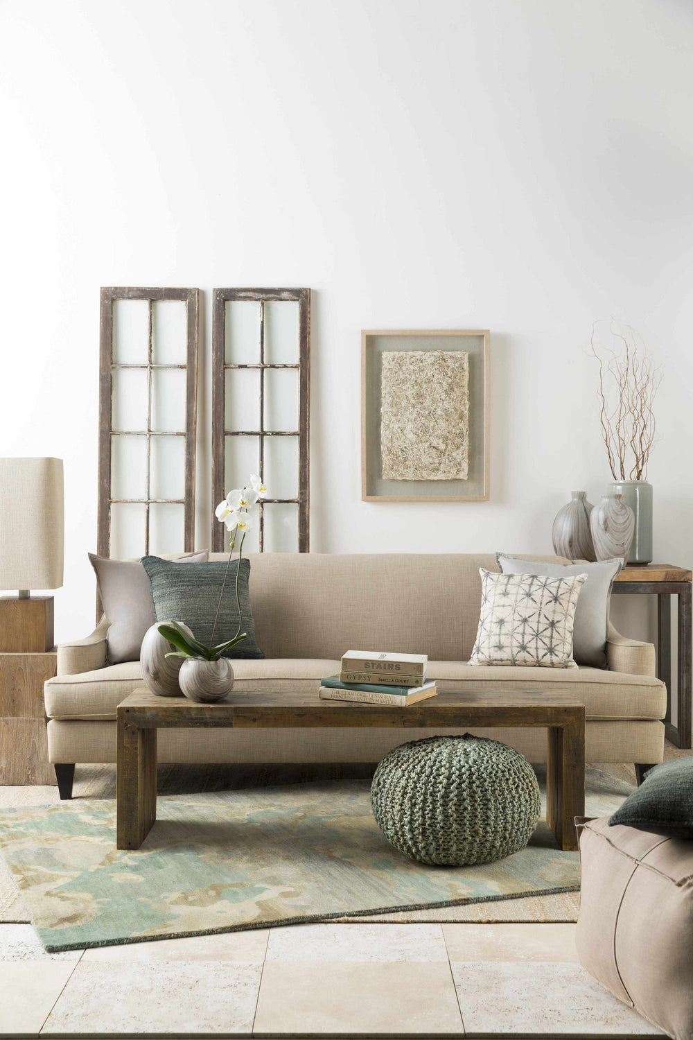 Living room scene with Briceville Premium Area Rug in ivory, green, blue, peach, and wheat colors. Contemporary, mid-century modern style. Styleshot