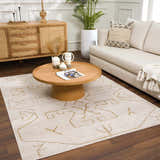Living room scene with a cream sofa and the Azzan Cream & Gold Area Rug, featuring a geometric design. Roomscene-Rectangle
