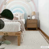 Kids bedroom with a Palimbang Cream 3D Rug, wood bed frame, rainbow wall art, and natural wood nightstand. Roomscene-Rectangle