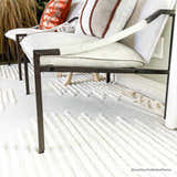 Living room scene with modern chairs on a Palimbang Cream 3D Rug. The rug has a geometric pattern and soft texture. Roomscene-Rectangle