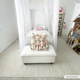 Light and airy kids bedroom with a Palimbang Cream 3D Rug, canopy bed, and white ottoman with stuffed animals. Roomscene-Rectangle