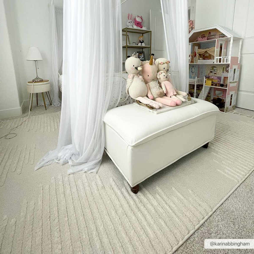 Kids room with a white ottoman on the Palimbang Cream 3D Rug. The rug has a subtle geometric pattern. Roomscene-Rectangle