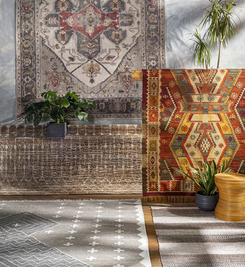Styled rug display featuring the Lodwar Area Rug in charcoal, cream, and gray with bohemian patterns. Styleshot