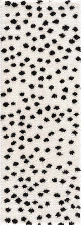 Close-up of the Cansu Black & White Dotted Area Rug, featuring a shag texture and a playful black polka dot pattern. Design-Runner