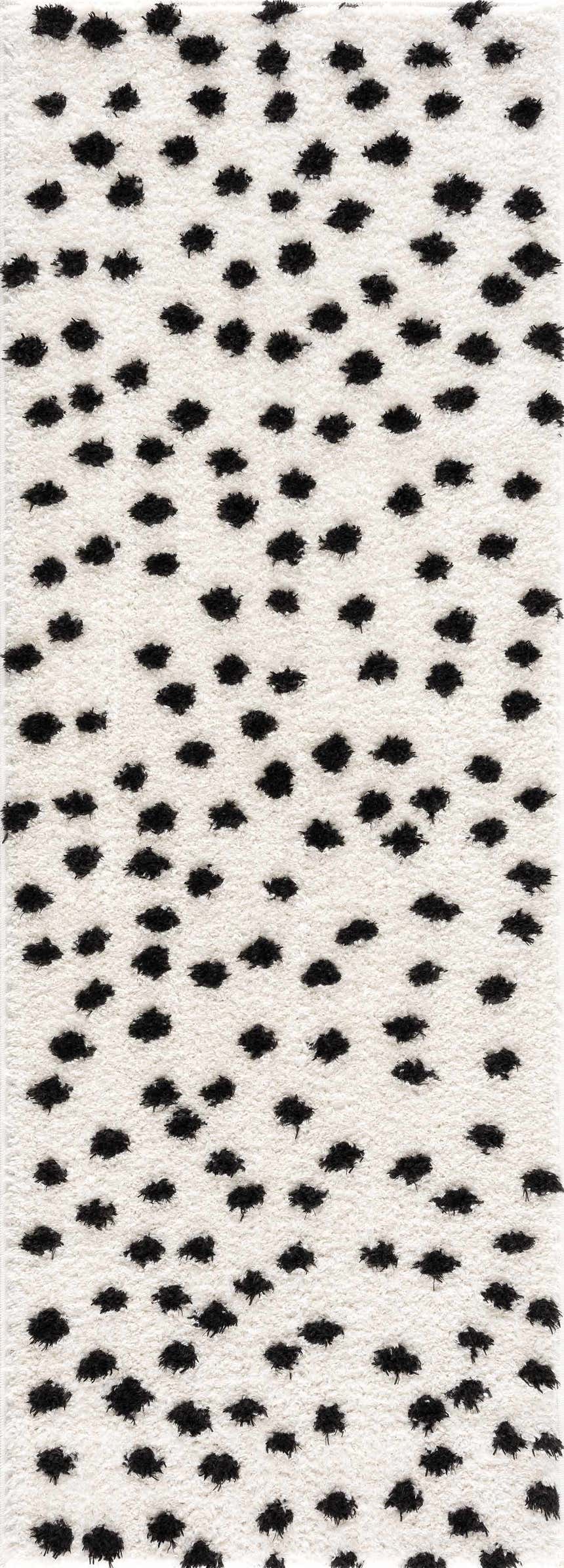 Close-up of the Cansu Black & White Dotted Area Rug, featuring a shag texture and a playful black polka dot pattern. Design-Runner