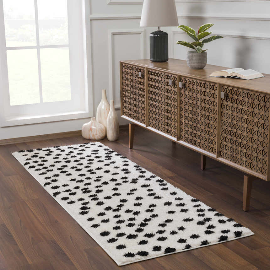 Entryway with a Cansu Black & White Dotted Area Rug, wood floors, console table, and natural light. Roomscene-Runner