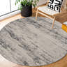 Cozy reading nook with a round Tigrima 2320 Ivory & Gray Rug, wood chair, and potted plant on hardwood floors. Roomscene-Round