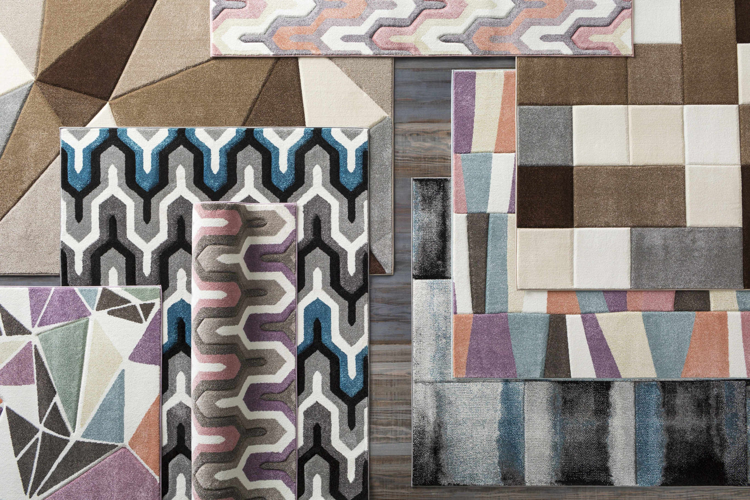 Overhead shot of assorted Clinton Area Rugs in geometric, striped, and patchwork designs. Aqua, brown, ivory, and taupe colors. Styleshot