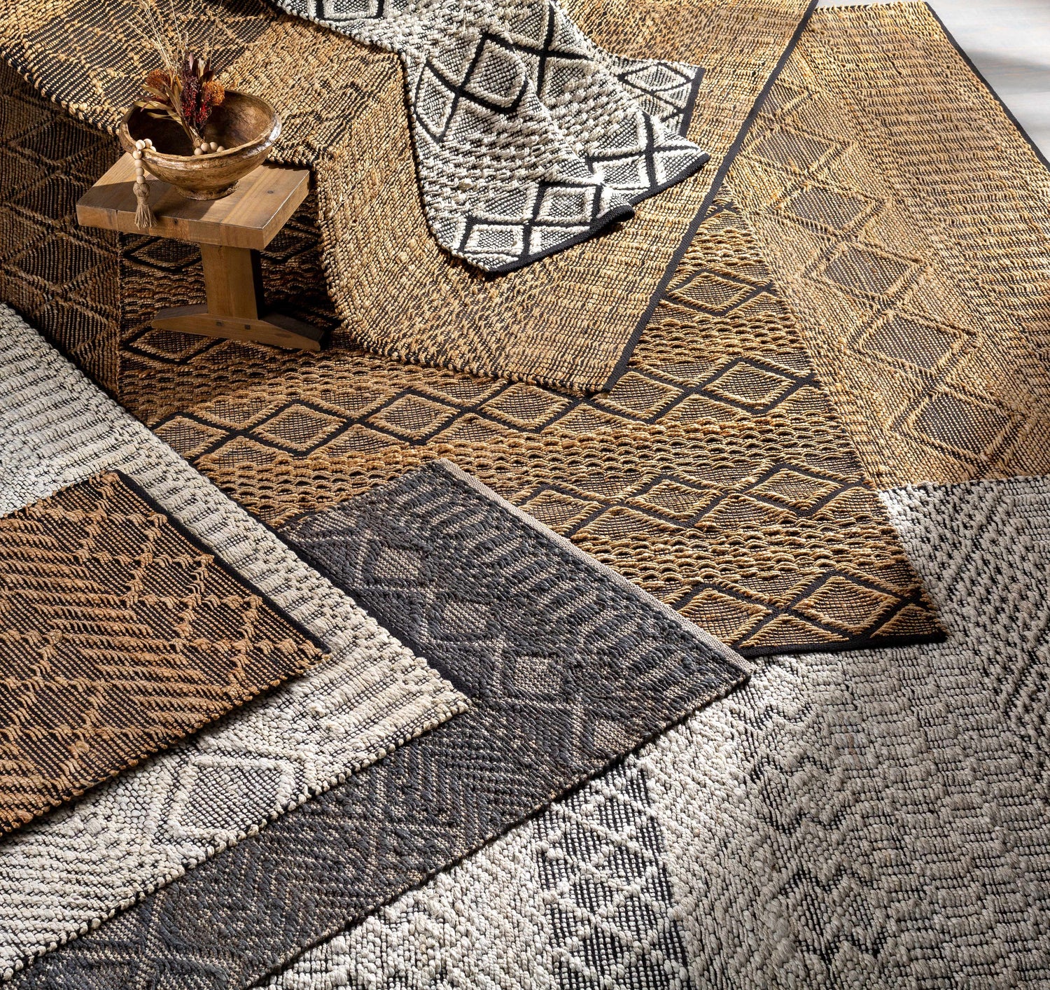 Close-up of hand-woven Malidong Jute Carpet in black, tan, and gray. Features geometric, bohemian, and farmhouse patterns. Styleshot