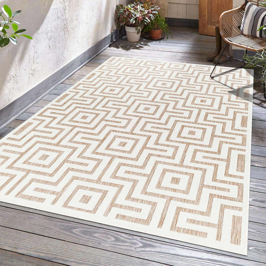 Outdoor patio scene with a Zevi Tan Outdoor Rug featuring a geometric maze pattern in tan and cream. Roomscene-Rectangle