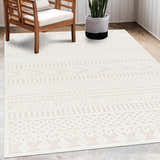 Living room scene with a Southwestern Jove Cream Outdoor Rug, wood chair, and potted snake plant. Roomscene-Rectangle