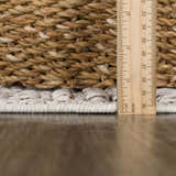 Close-up of Nyla Bone rug texture with ruler showing pile height. Bone colored polypropylene rug. Pile