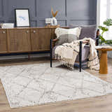 Contemporary mudroom with Nyla Bone Indoor Outdoor Rug, wood cabinet, gray chair, and natural accents. Roomscene-Rectangle