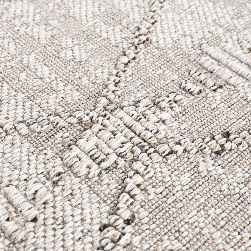 Close-up of the Nyla Bone Indoor Outdoor Rug, showing woven texture and geometric pattern in neutral bone tones. Texture