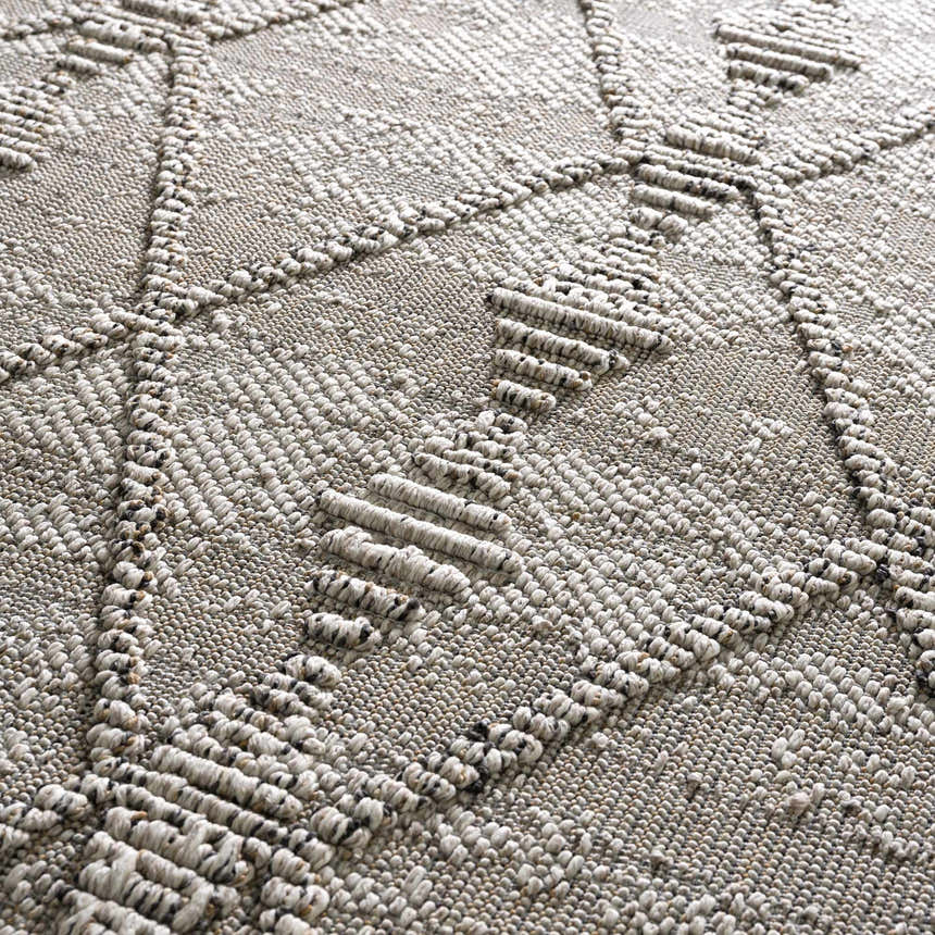 Close-up of the Nyla Bone Indoor & Outdoor Rug showing its woven texture and geometric design in neutral bone tones. Texture