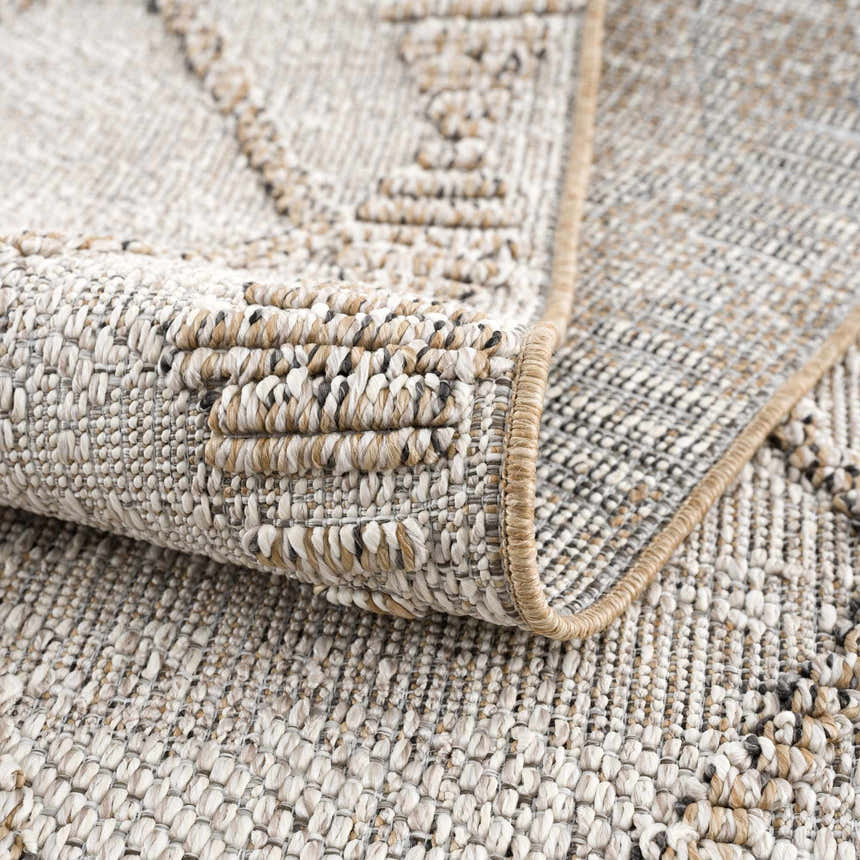 Close-up of the textured Nyla Bone & Tan Performance Rug, showing the woven design and neutral color palette. Fold