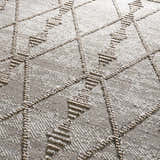 Close-up of the Nyla Bone & Tan Textured Performance Rug, featuring a geometric diamond pattern and woven texture. Texture