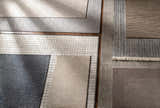 Close-up of various Angie Area Rugs in charcoal, beige, and gray, showing striped, solid, and grid patterns. Styleshot
