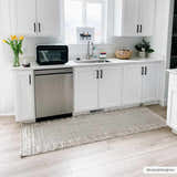 Bright kitchen with white cabinets and Sulak Cream Area Rug in light beige and gray. Roomscene-Runner