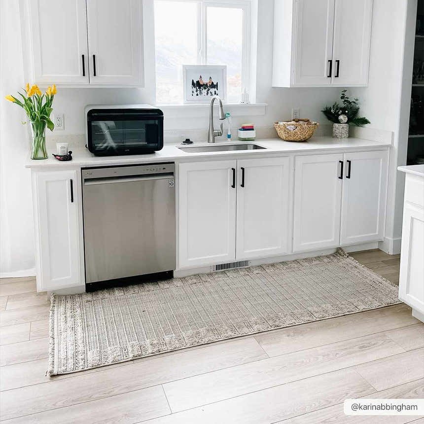 Bright kitchen with white cabinets and Sulak Cream Area Rug in light beige and gray. Roomscene-Runner