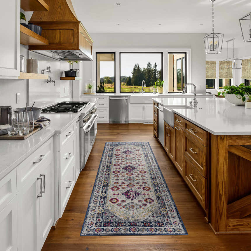 Bright kitchen with white cabinets and wood island featuring Tigrim Beige 2306 runner rug. Roomscene-Runner