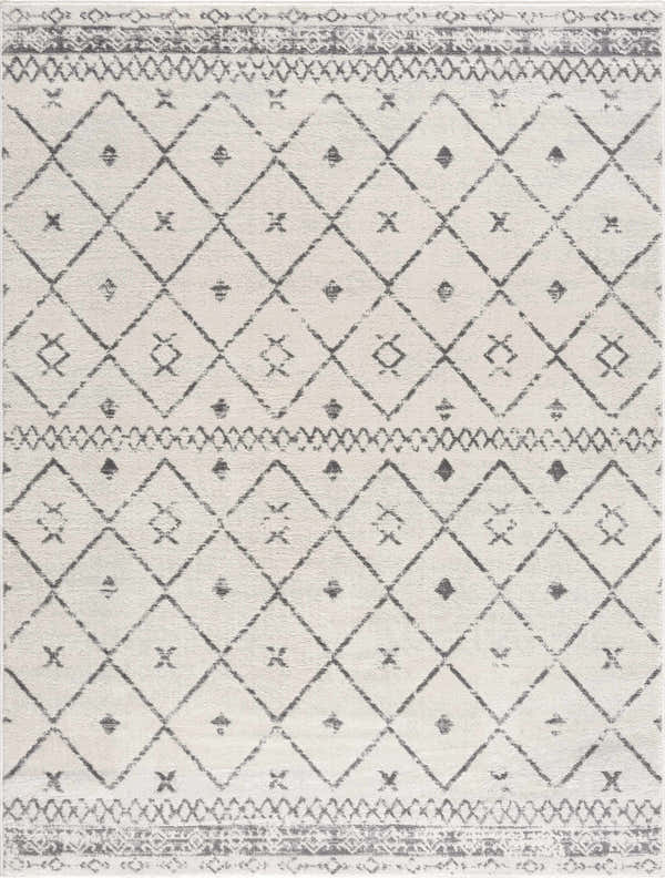 Close-up of Tigris Area Rug, a machine-woven rug with a geometric diamond pattern in charcoal gray and white. Design-Rectangle-5373