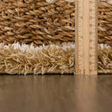 Close-up of the Calup Shag Area Rug pile height in bone and brown, showing the texture and thickness. Pile
