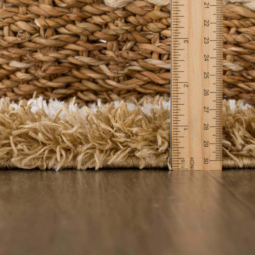 Close-up of the Calup Shag Area Rug pile height in bone and brown, showing the texture and thickness. Pile