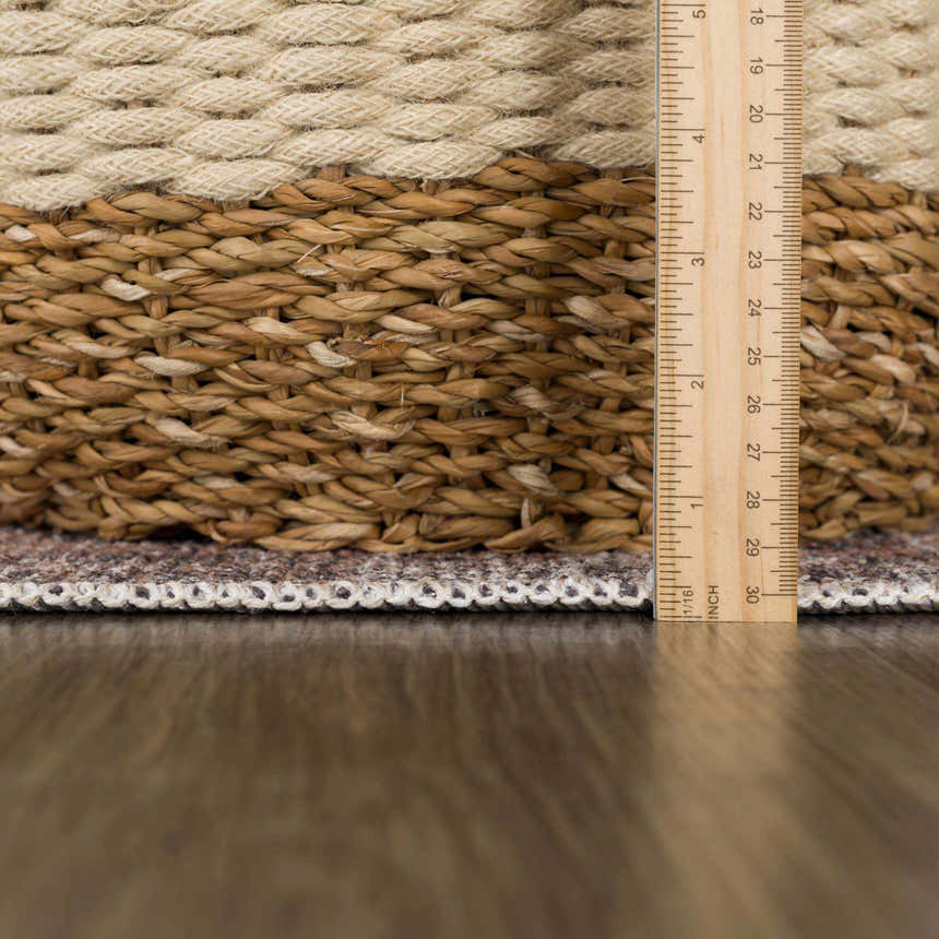 Close-up of Orsin Washable Area Rug showing texture, pile height, and braided edge detail with a ruler for scale. Pile
