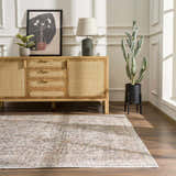 Living room scene with a light wood cabinet and the Orsin Washable Area Rug in neutral tones on a dark wood floor. Roomscene-Rectangle