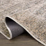 Close-up of Ohoud Washable Area Rug showing texture, neutral colors, traditional pattern, and machine-woven construction. Fold