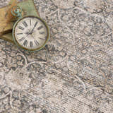 Close-up of the Ohoud Washable Area Rug. Neutral tones with a traditional, distressed pattern and soft texture. Styleshot