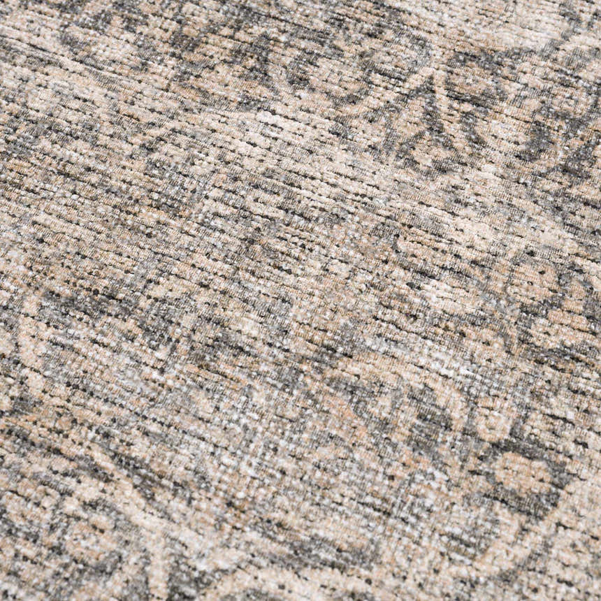 Close-up of the Ohoud Washable Area Rug showing its beige, cream, and gray traditional pattern and textured weave. Texture