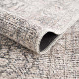 Close up of the Odele Washable Area Rug in medium gray, showing the chenille polyester texture and machine-woven construction. Fold