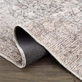 Close-up of the Odele Washable Area Rug in medium gray. Chenille polyester and cotton rug with a traditional pattern. Fold