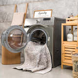 Farmhouse laundry room with gray Odele Washable Area Rug partially in the washing machine. Washing-Machine