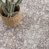 Close-up of the Odele Washable Area Rug in medium gray, featuring a traditional, subtly distressed pattern and soft texture. Styleshot
