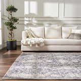 Living room scene with a neutral couch and the Mohan Washable Area Rug in gray and beige tones. Roomscene-Rectangle